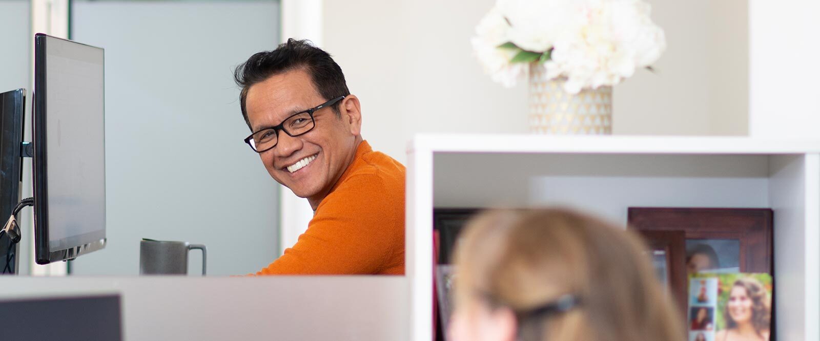Man smiling at coworker